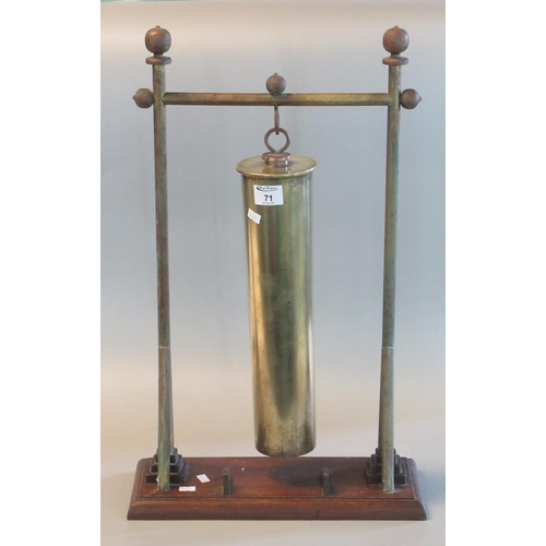 71 - Brass dinner gong formed from a shell case on a brass stand with rectangular moulded wooden base. 64... 