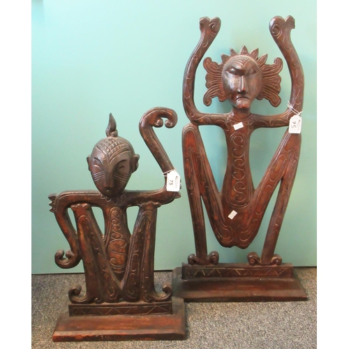 75 - Two similar probably African stained wooden stylised ceremonial figures, probably depicting monkeys.... 