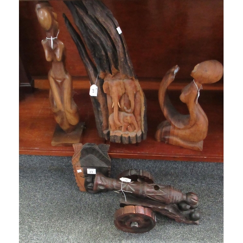 79 - Group of probably African carved figures and ornaments, elephant group, mask, together with a wooden... 