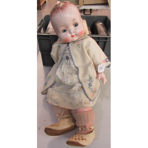 406 - Vintage life-size baby doll with moveable limbs (plastic) in vintage cloths.   (B.P. 21% + VAT)