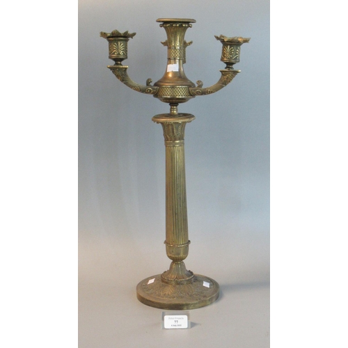 77 - Gothic design brass three branch table candelabra with acanthus leaf  decoration.  (B.P. 21% + VAT)