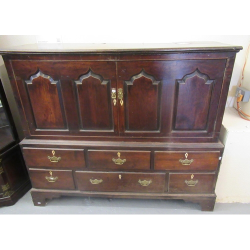 76 - Early 19th Century Welsh oak two stage press cupboard of low proportions, the moulded top above two ... 