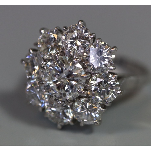 233 - Diamond cluster ring of a central brilliant cut diamond surrounded by eight brilliant cut diamonds. ... 