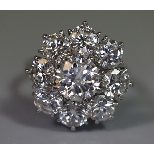 233 - Diamond cluster ring of a central brilliant cut diamond surrounded by eight brilliant cut diamonds. ... 