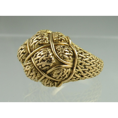 238 - A yellow metal ring heavily engraved and shaped with basketwork shoulders.  Ring size P.  Engraved t... 