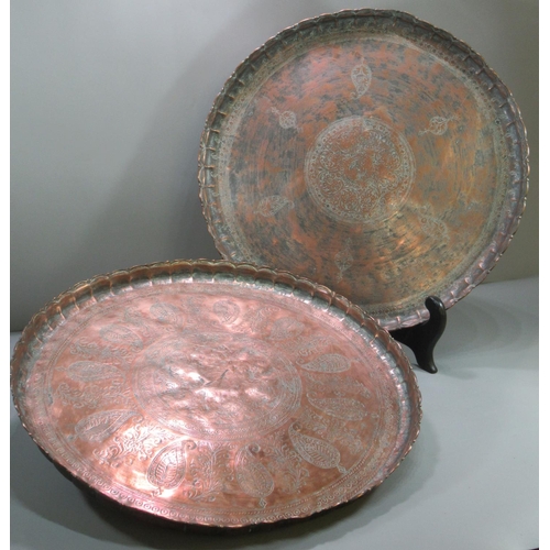 154 - Two similar Turkish copper 'Tepsi' trays engraved with stylised flowers and foliage.  49cm diameter ... 