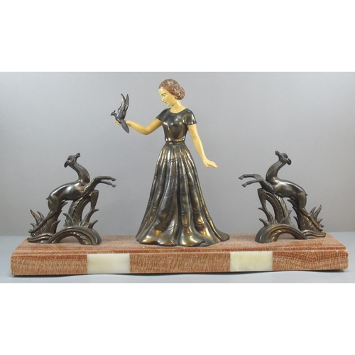 161 - Art Deco design spelter group of a young lady holding a bird in her hand flanked by two leaping stag... 