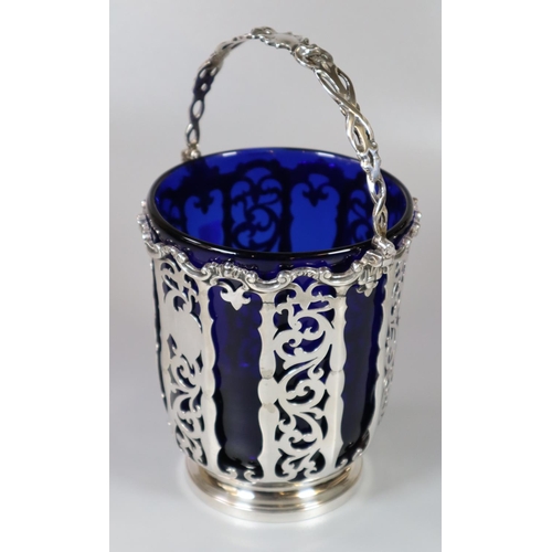 213 - Victorian silver and pierced basket with swing handle and Bristol Blue glass liner by George John Ri... 