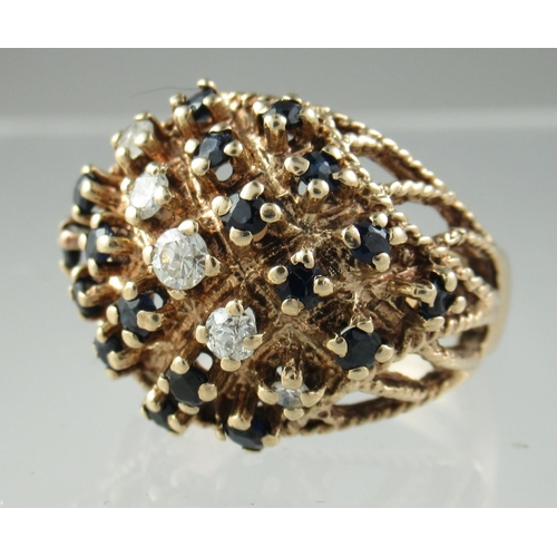 218 - 9ct gold diamond and sapphire cluster ring.  Ring size Q.  Approx weight 8g. 
(B.P. 21% + VAT)