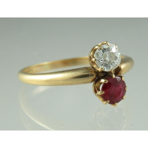 219 - A two stone diamond and ruby ring on 18ct gold band.  Ring size P.  Approx weight 2.7 grams.  
 (B.P... 