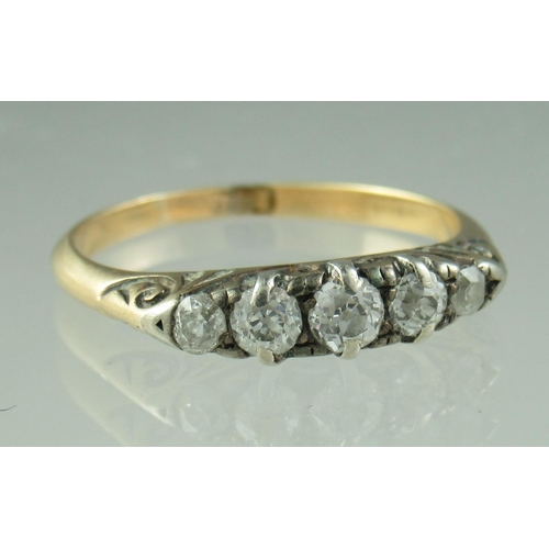 221 - A five stone diamond ring, the old cut stones graduated from the centre in an 18ct gold mount.  Ring... 