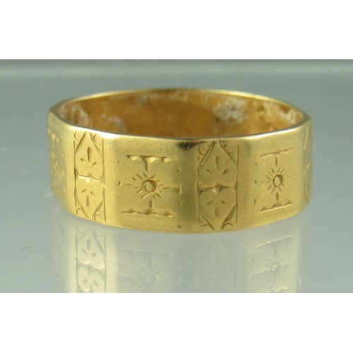 225 - A 22ct gold shaped and engraved wedding ring.  Width 7mm.  Ring size Q.  Approx weight 5.7 grams.
 (... 