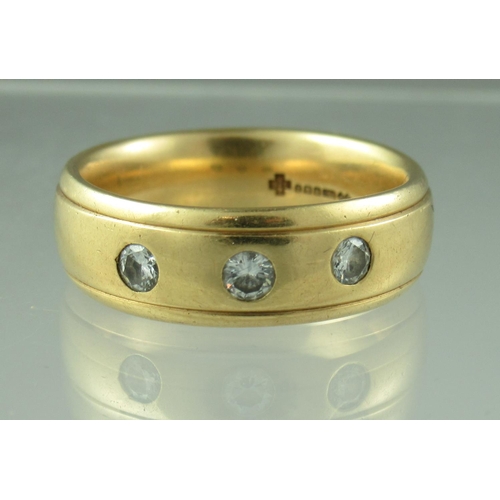 237 - An 18ct gold three stone diamond ring.  The three brilliant cut diamonds flush set in an 18ct gold b... 