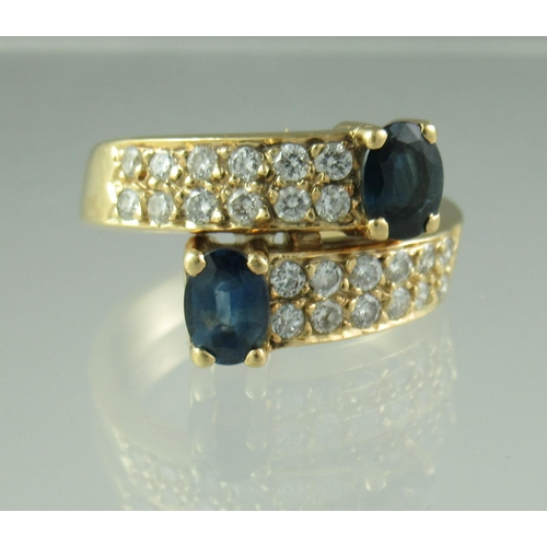 239 - Sapphire and diamond crossover ring with 18ct gold band.  Ring size K.   Approx weight 6.1 grams.
 (... 