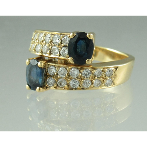 239 - Sapphire and diamond crossover ring with 18ct gold band.  Ring size K.   Approx weight 6.1 grams.
 (... 