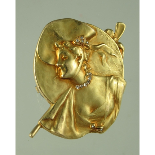 243 - A signed Georges Van dear Straeten Art Nouveau brooch depicting a well dressed lady with diamond nec... 