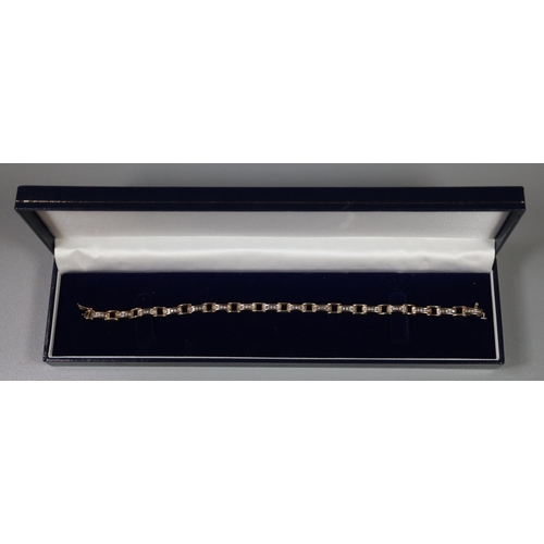 263 - A diamond line bracelet set in 9ct gold with safety clasp.  Approx weight 10.8 grams.
  (B.P. 21% + ... 