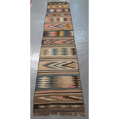 298 - 20th century geometric kelim multicoloured runner.  328x70cm approx.   (B.P. 21% + VAT)