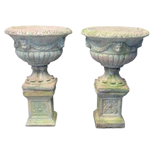 77 - Pair of 20th century weathered composition garden Campana shaped urns having moulded lion mask mount... 