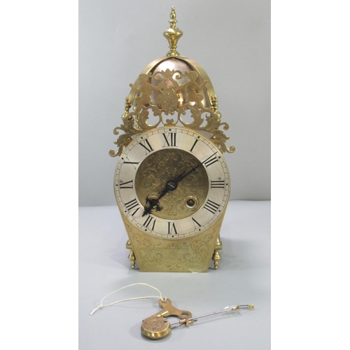 91 - Dutch style brass lantern clock, having baluster finial above brass bell, pierced figural pediment w... 