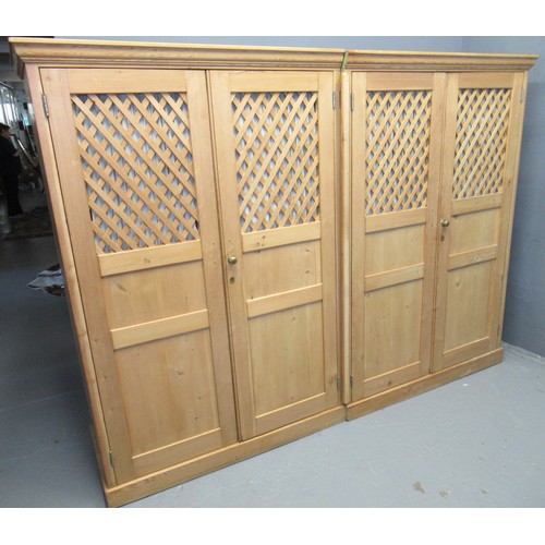 82 - Late 19th century pine four door wardrobe, the moulded cornice above four lattice panels having turn... 