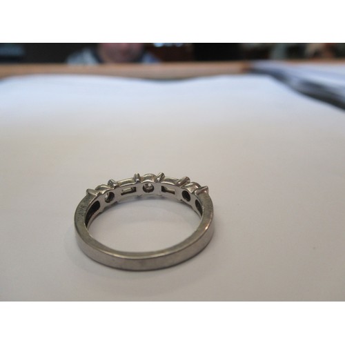 228 - A diamond half eternity style ring set with three brilliant cut and two baguette cut diamonds.  Ring... 