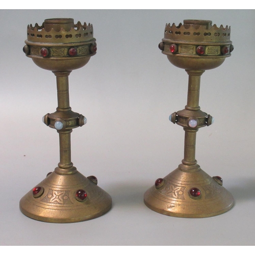 47 - Pair of brass gothic revival style candlesticks decorated with cabochon stones. 15cm high approx. 
(... 
