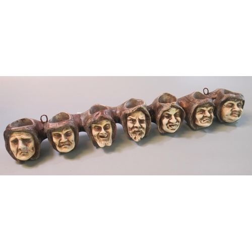 58 - Novelty pipe rack in the form of seven medieval style monk heads. 
(B.P. 21% + VAT)