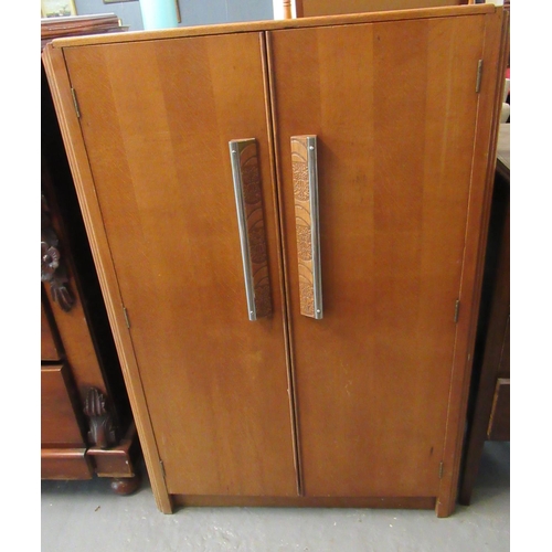 471 - Art Deco design oak two door blind panel cupboard, the interior revealing shelves and a bank of five... 