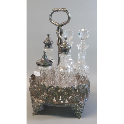 18 - Silver plated and glass five piece cruet set with entwined handle, the base decorated with vines and... 