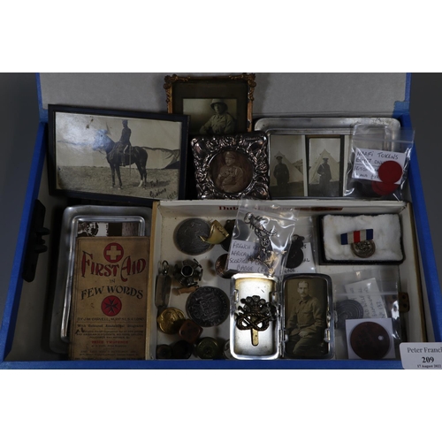 209 - A box of military interest items, to include: badges, photographs, coins, brooches, tokens  etc. 
 (... 