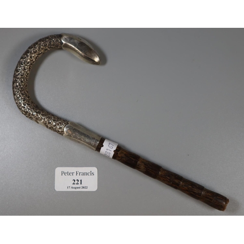 221 - Silver foliate decorated parasol handle with part malacca cane stem.  London hallmarks.  (B.P. 21% +... 