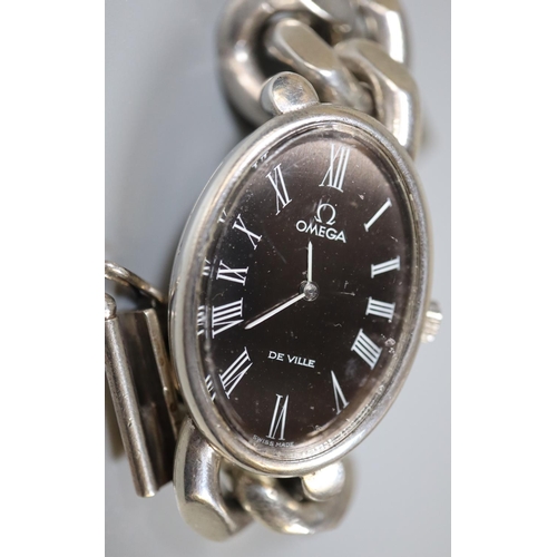 267 - Omega de Ville heavy silver oval wristwatch with roman numerals on a heavy curb link Omega bracelet.... 