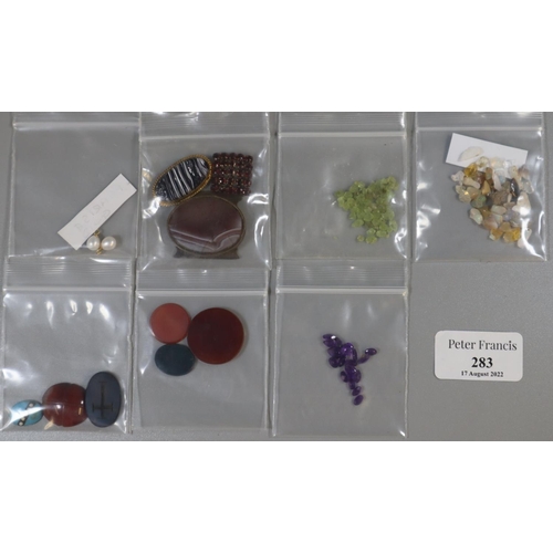 283 - Box of assorted unmounted semi precious stones: opal, blood stone, jet etc.  (B.P. 21% + VAT)