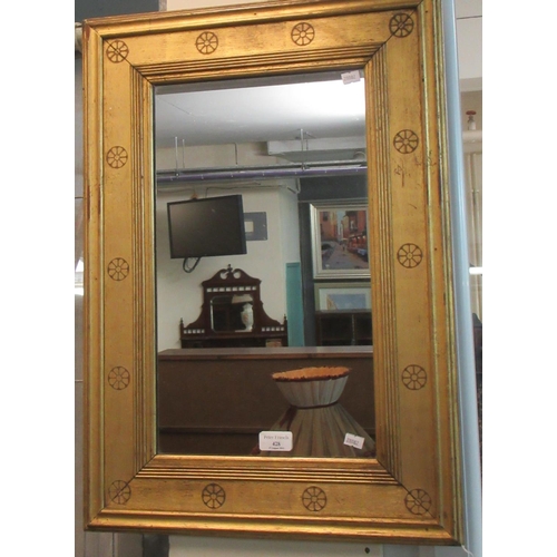 428 - Gilt framed mirror of rectangular form decorated with flower heads.  (B.P. 21% + VAT)