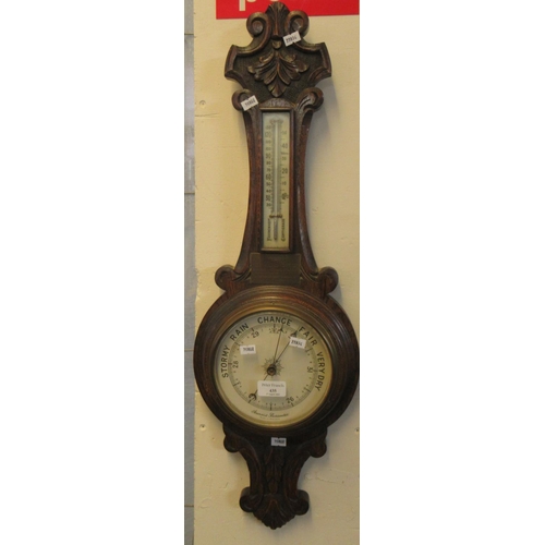 435 - Early 20th century carved oak presentation aneroid barometer, the plaque dated 1933.  (B.P. 21% + VA... 