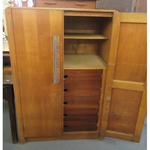 471 - Art Deco design oak two door blind panel cupboard, the interior revealing shelves and a bank of five... 