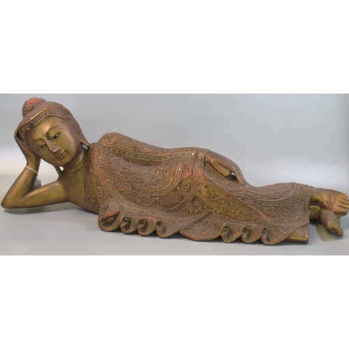 5 - Carved wood gilded Thai figure of a recumbent goddess in jewelled robe.  65cm long approx.  (B.P. 21... 