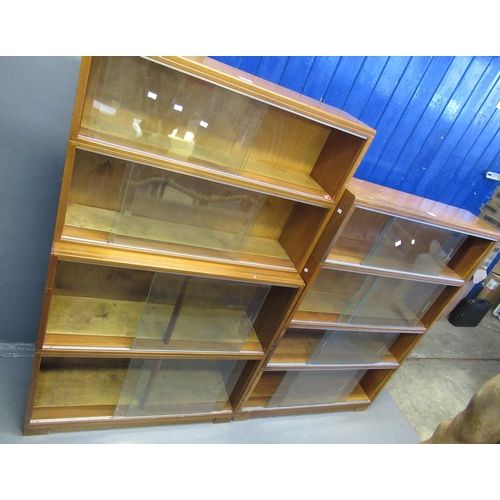 546 - Two Minty similar four section library bookcase with glass sliding doors.  (2)  (B.P. 21% + VAT)