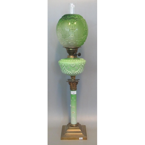 68 - Early 20th century double oil burner lamp having green and clear glass etched globular shade above a... 