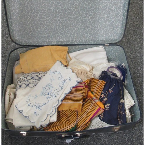 104 - Suitcase of assorted linen, to include: table ware, lace, table throws etc.  (B.P. 21% + VAT)