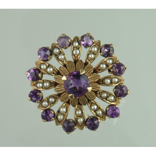 283 - A Victorian circle brooch set with amethyst and seed pearls.  Diameter approx 27mm.  Approx weight 5... 