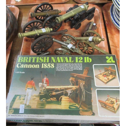 336 - Collection of metal miniature decorative cannons in various sizes and metals and a boxed British Nav... 