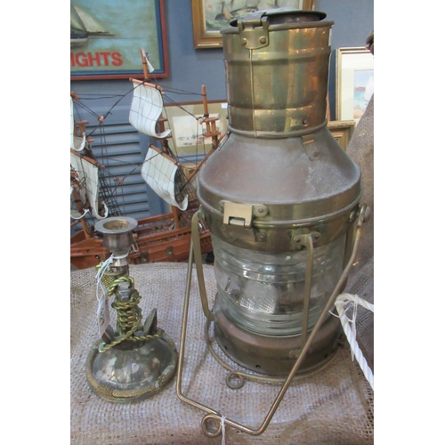 429 - Brass marine oil lantern and a nautical candlestick, adorned with ship's anchor (2)  (B.P. 21% + VAT... 