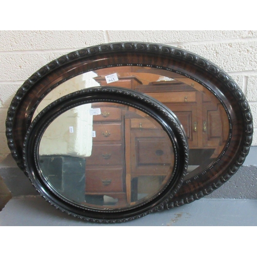 443 - Large oval carved wooden framed mirror, together with a smaller ebonised oval wooden framed mirror (... 