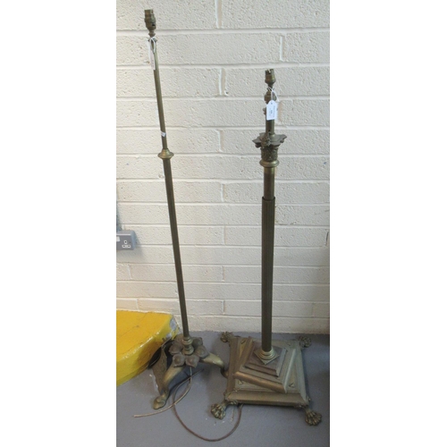 446 - Two brass standard lamps, one with a Corinthian column and substantial decorative base with paw feet... 