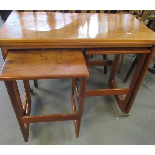 507 - Nest of three teak coffee table in G plan style on casters.  (2+1)  (B.P. 21% + VAT)