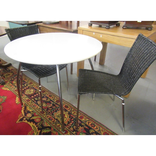 514 - Mid 20th century white melamine circular table on chrome legs together with a pair of black caned ch... 