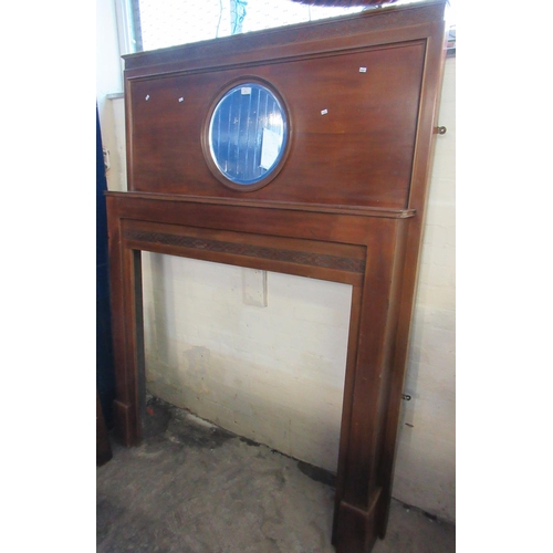 551 - Early 20th century mahogany fire surround with circular bevelled mirror and strapwork banding.  (B.P... 