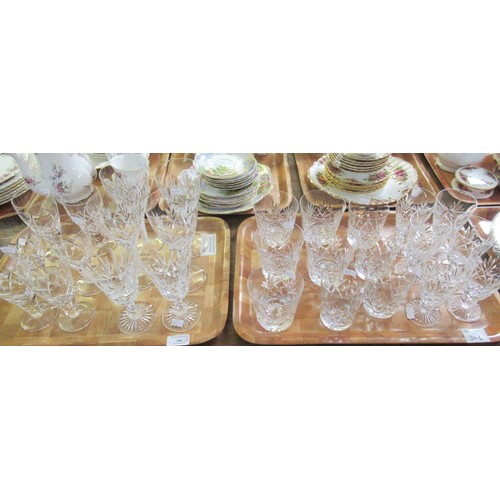 346 - Four trays of mostly cut glass items to include; various drinking vessels some with star cut bases; ... 